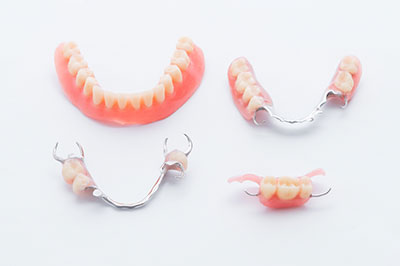 The image shows a collection of dental implants with crowns on a white background, presented in a way that suggests they are for sale or display.