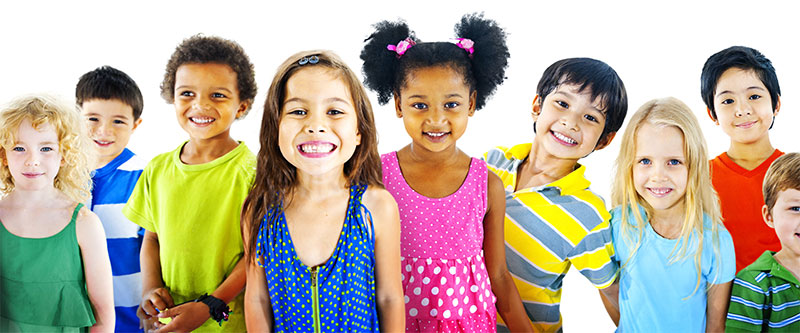 The image shows a group of children of various ages and ethnicities posing together with smiles, against a white background.